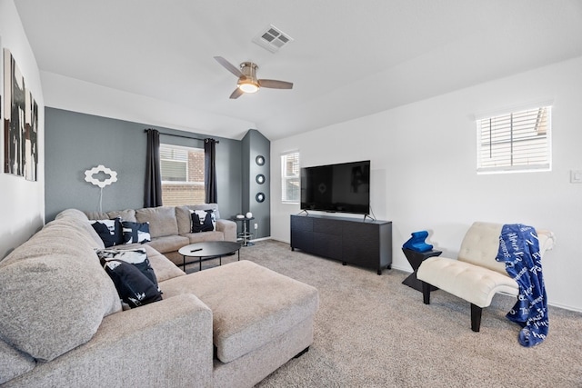 carpeted living room featuring ceiling fan, vaulted ceiling, and a wealth of natural light