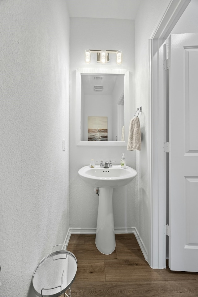 bathroom with wood-type flooring