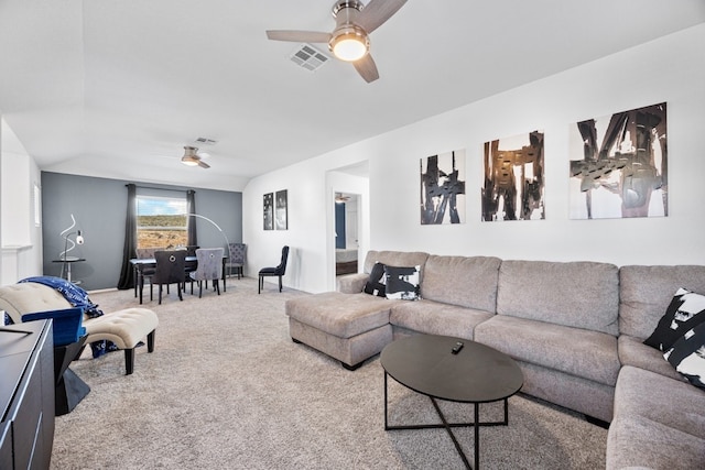 carpeted living room with ceiling fan