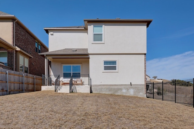 back of property featuring a patio and a lawn