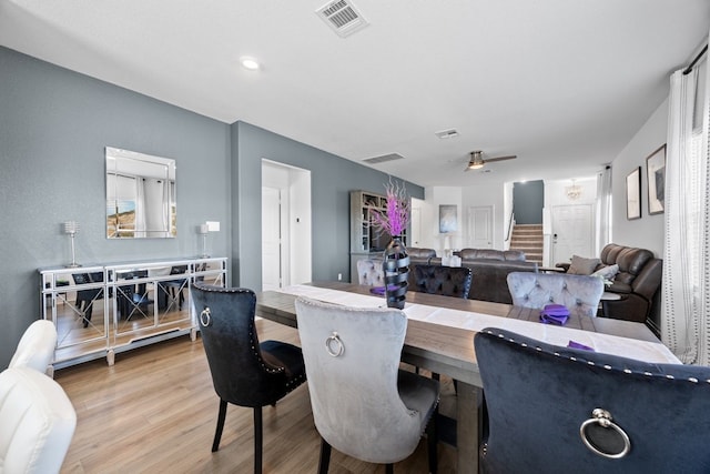 dining space with ceiling fan and hardwood / wood-style floors