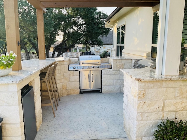 view of patio / terrace with grilling area, exterior kitchen, and exterior bar