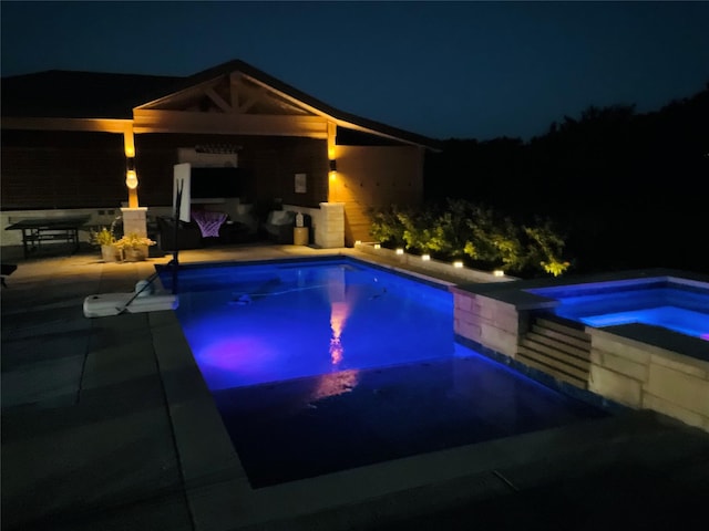 view of swimming pool with an in ground hot tub and a patio