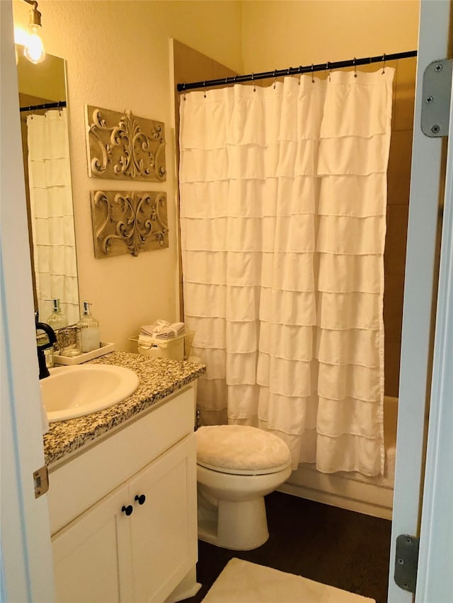 full bathroom with vanity, toilet, and shower / bathtub combination with curtain