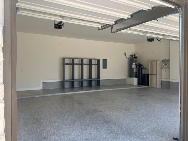 garage with a garage door opener and water heater