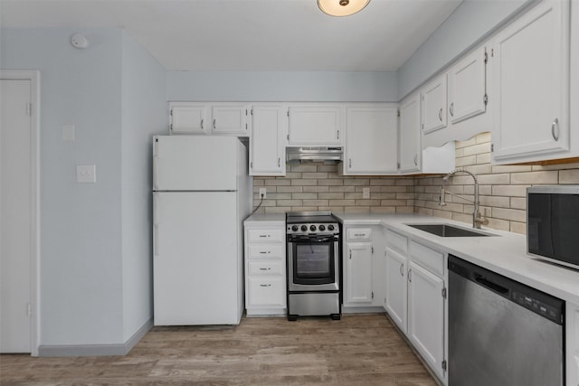 kitchen featuring sink, decorative backsplash, stainless steel appliances, and white cabinets