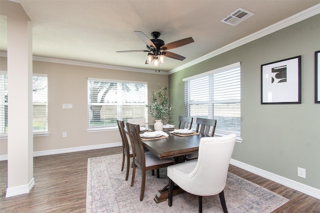 dining room with ornamental molding, a healthy amount of sunlight, hardwood / wood-style floors, and ceiling fan