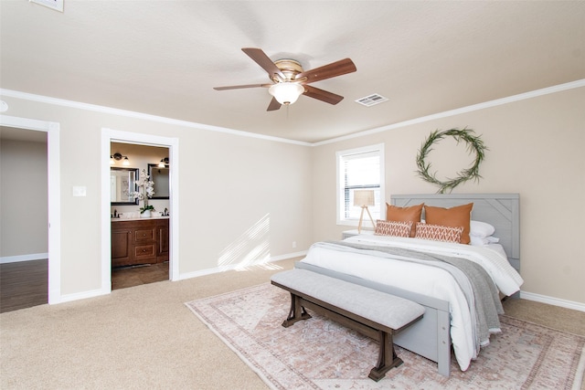 carpeted bedroom with ornamental molding, connected bathroom, and ceiling fan