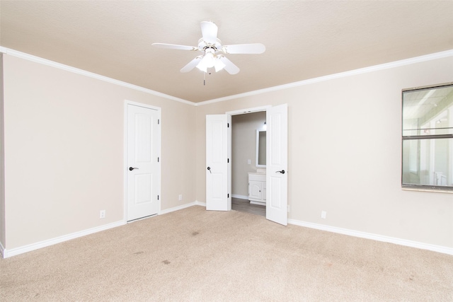 carpeted spare room featuring ornamental molding and ceiling fan