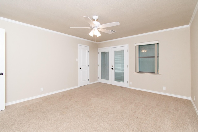 unfurnished room with french doors, ceiling fan, ornamental molding, and light carpet