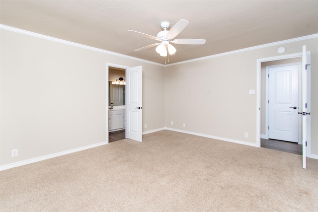 empty room with ornamental molding, carpet floors, and ceiling fan