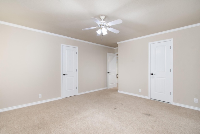 spare room featuring crown molding, carpet floors, and ceiling fan