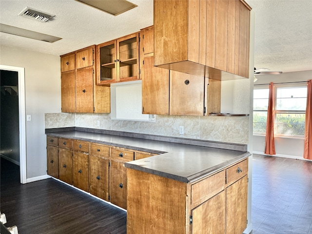 kitchen with ceiling fan, a textured ceiling, and backsplash