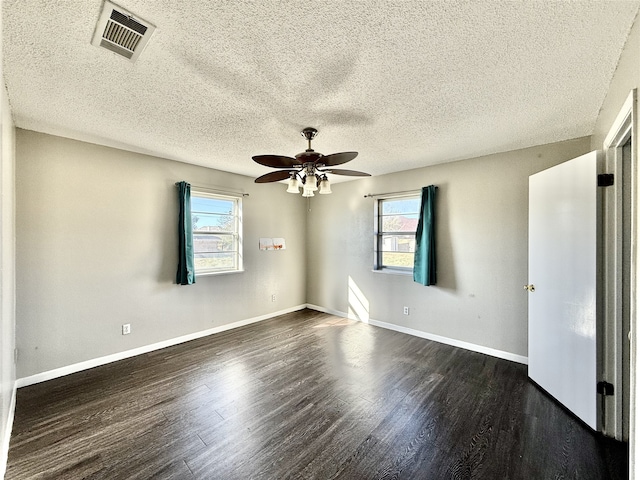 unfurnished room featuring dark hardwood / wood-style flooring, a textured ceiling, and ceiling fan