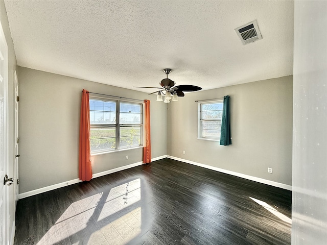 unfurnished room with ceiling fan, dark hardwood / wood-style flooring, and a textured ceiling