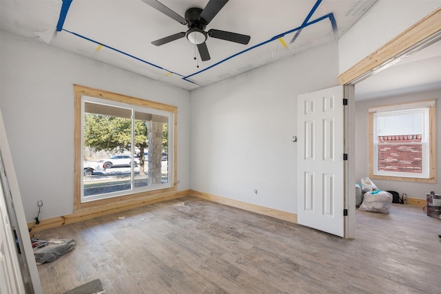 unfurnished room featuring ceiling fan and hardwood / wood-style floors