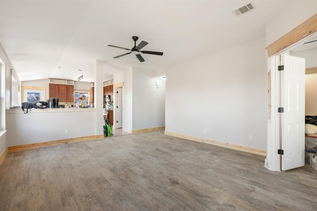 unfurnished living room with ceiling fan, wood-type flooring, and vaulted ceiling