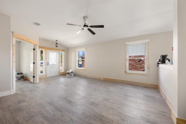 interior space featuring ceiling fan, light hardwood / wood-style floors, and vaulted ceiling