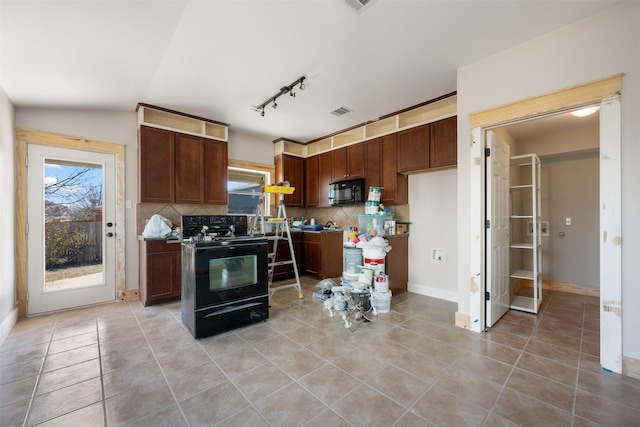 kitchen with lofted ceiling, tasteful backsplash, light tile patterned floors, track lighting, and black appliances