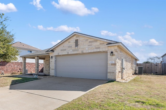 ranch-style house featuring a garage, cooling unit, and a front lawn