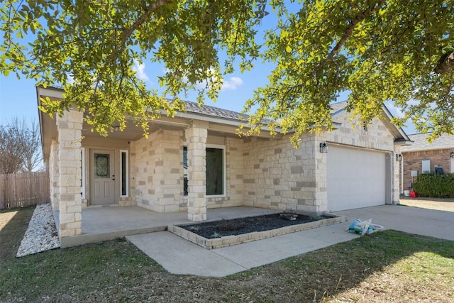 1016 Flanagan Dr, Leander, TX 78641 - view of front of home with an attached garage, driveway, and stone siding
