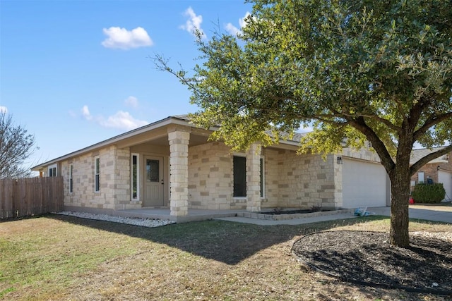 1016 Flanagan Dr, Leander, TX 78641 - view of front of property featuring an attached garage, stone siding, and concrete driveway
