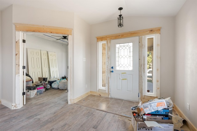 entrance foyer featuring lofted ceiling, ceiling fan, and light wood-type flooring