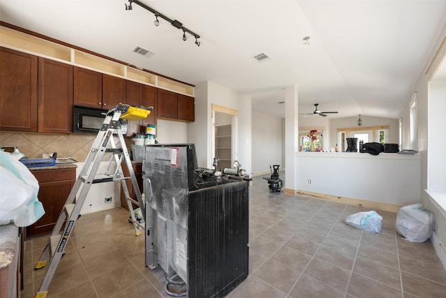 kitchen featuring lofted ceiling, tasteful backsplash, ceiling fan, and light tile patterned flooring