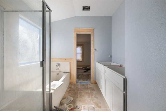 1016 Flanagan Dr, Leander, TX 78641 - full bath with a garden tub, vaulted ceiling, vanity, and an enclosed shower