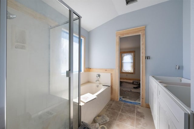 1016 Flanagan Dr, Leander, TX 78641 - full bathroom with vaulted ceiling, a garden tub, a shower stall, and vanity
