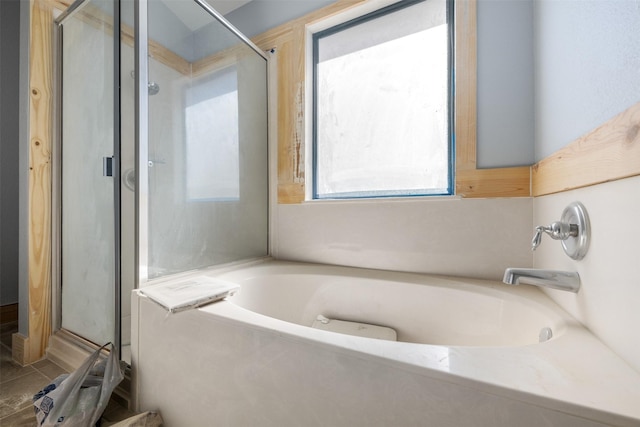 bathroom with separate shower and tub and a wealth of natural light