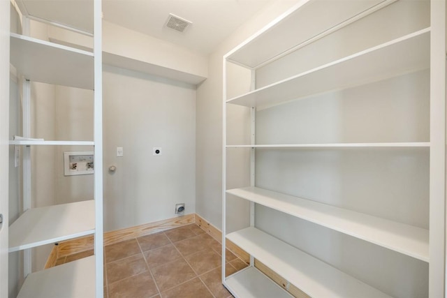1016 Flanagan Dr, Leander, TX 78641 - washroom with hookup for an electric dryer, hookup for a washing machine, and tile patterned flooring