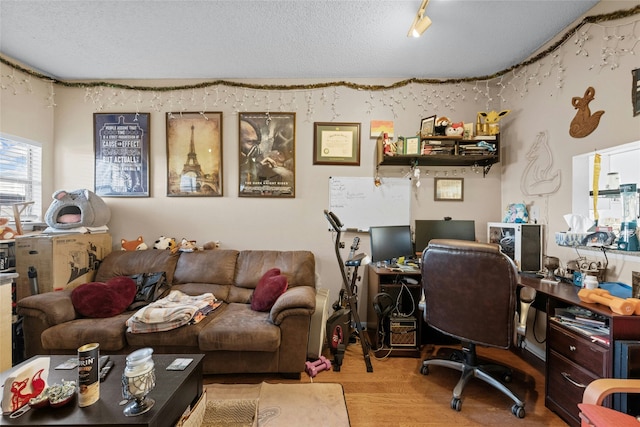 office featuring a textured ceiling and light wood-type flooring