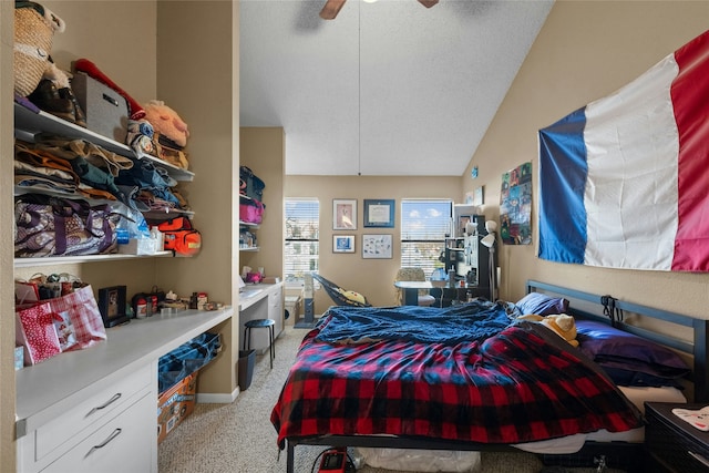 carpeted bedroom with ceiling fan, lofted ceiling, and a textured ceiling