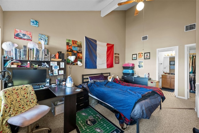 bedroom featuring connected bathroom, high vaulted ceiling, beamed ceiling, carpet flooring, and ceiling fan