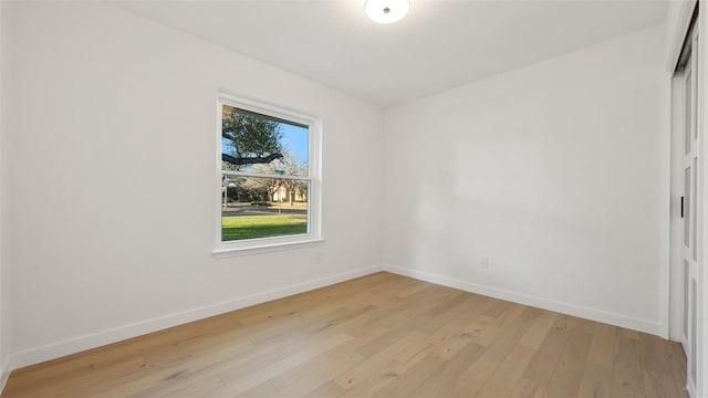 unfurnished room with light wood-type flooring