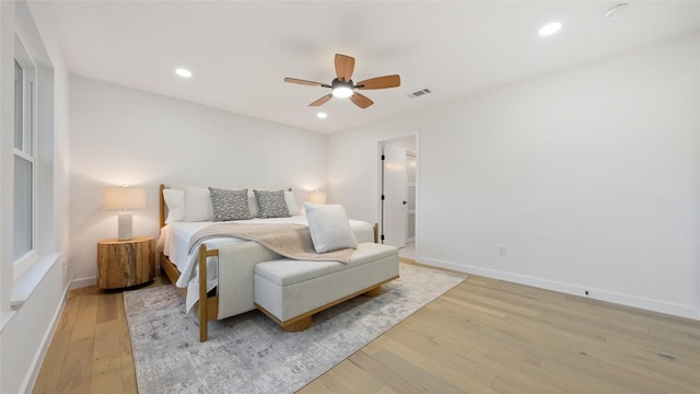 bedroom with ceiling fan and light wood-type flooring