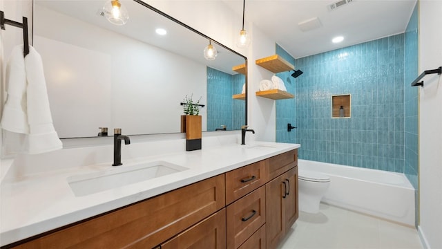 full bathroom featuring vanity, tile patterned flooring, tiled shower / bath combo, and toilet