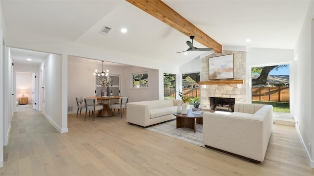 living room with a stone fireplace, ceiling fan with notable chandelier, light hardwood / wood-style flooring, and vaulted ceiling with beams