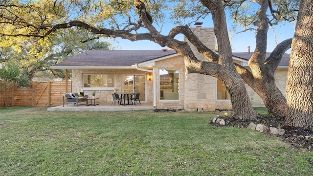 rear view of property featuring a yard and a patio area