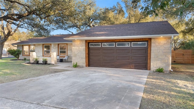 ranch-style house with a garage and a front lawn