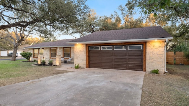 ranch-style house featuring a garage and a front yard