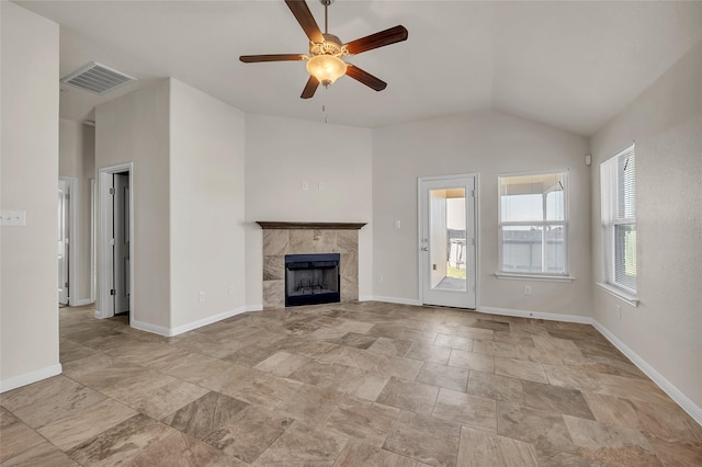 unfurnished living room with lofted ceiling, a fireplace, and ceiling fan