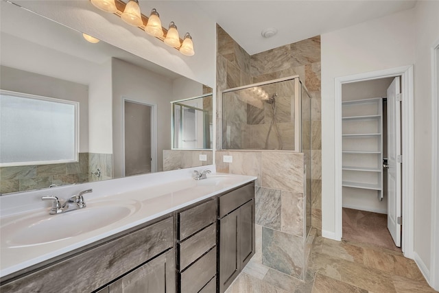 bathroom featuring vanity and a shower with shower door