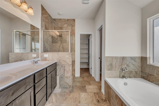 bathroom with vanity, separate shower and tub, and a healthy amount of sunlight