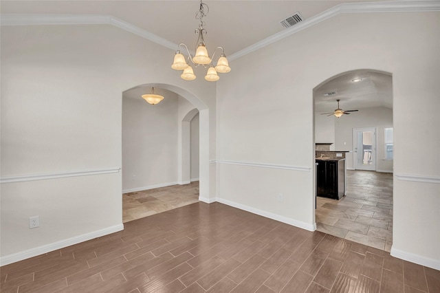 spare room with lofted ceiling, ceiling fan with notable chandelier, and ornamental molding