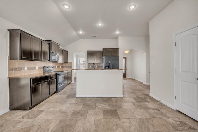 kitchen with lofted ceiling, a center island, tasteful backsplash, light stone countertops, and black appliances