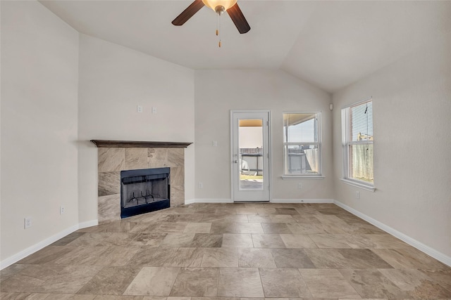 unfurnished living room featuring vaulted ceiling, ceiling fan, and a fireplace