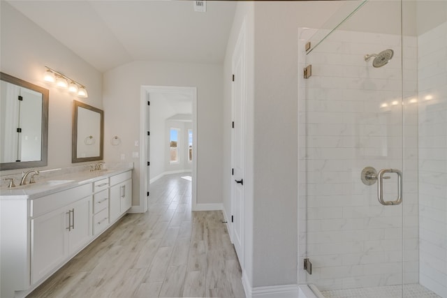 125 Serene Hilltop Cir, Austin, TX 78738 - full bath with a shower stall, double vanity, vaulted ceiling, wood finished floors, and baseboards