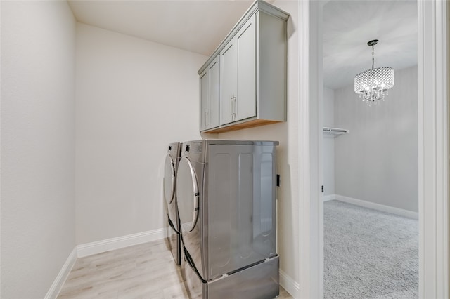125 Serene Hilltop Cir, Austin, TX 78738 - laundry room with separate washer and dryer, cabinet space, a chandelier, baseboards, and light wood-type flooring